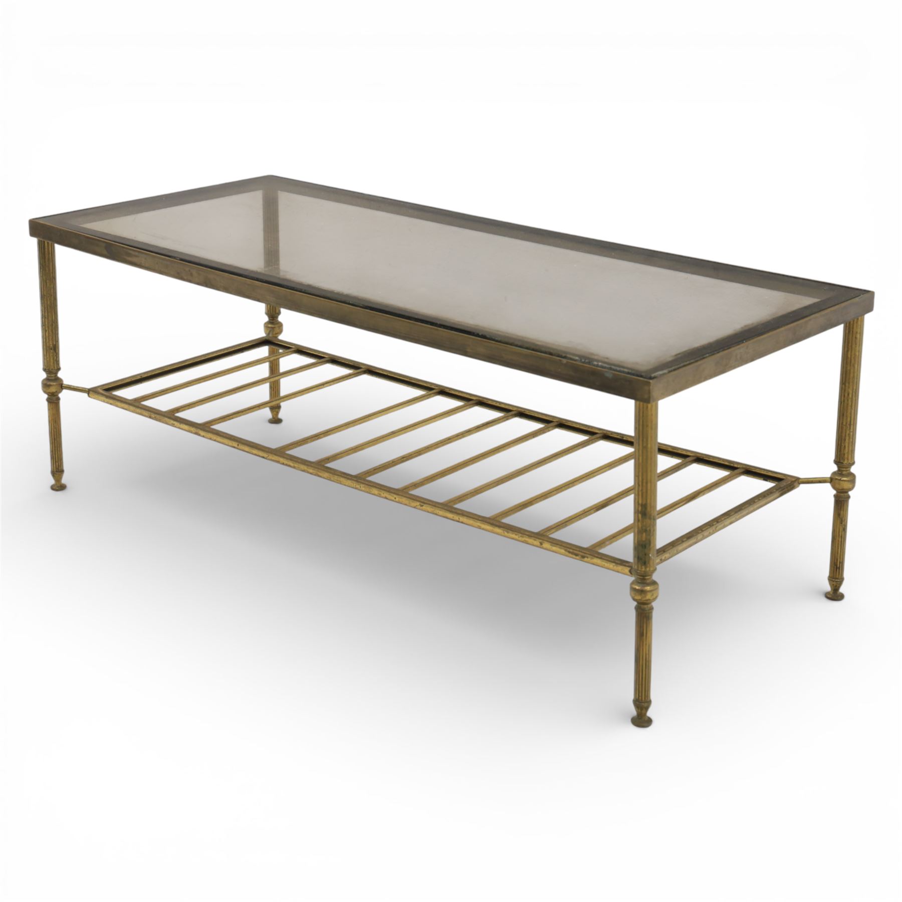 20th century brass and glass topped coffee table, the rectangular glass top within brass frame, upon four reeded legs united by lower slatted under tier 