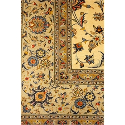  Large Persian Kashan ivory ground carpet, blue trailing foliage pattern, repeating border, 375cm x 253cm  