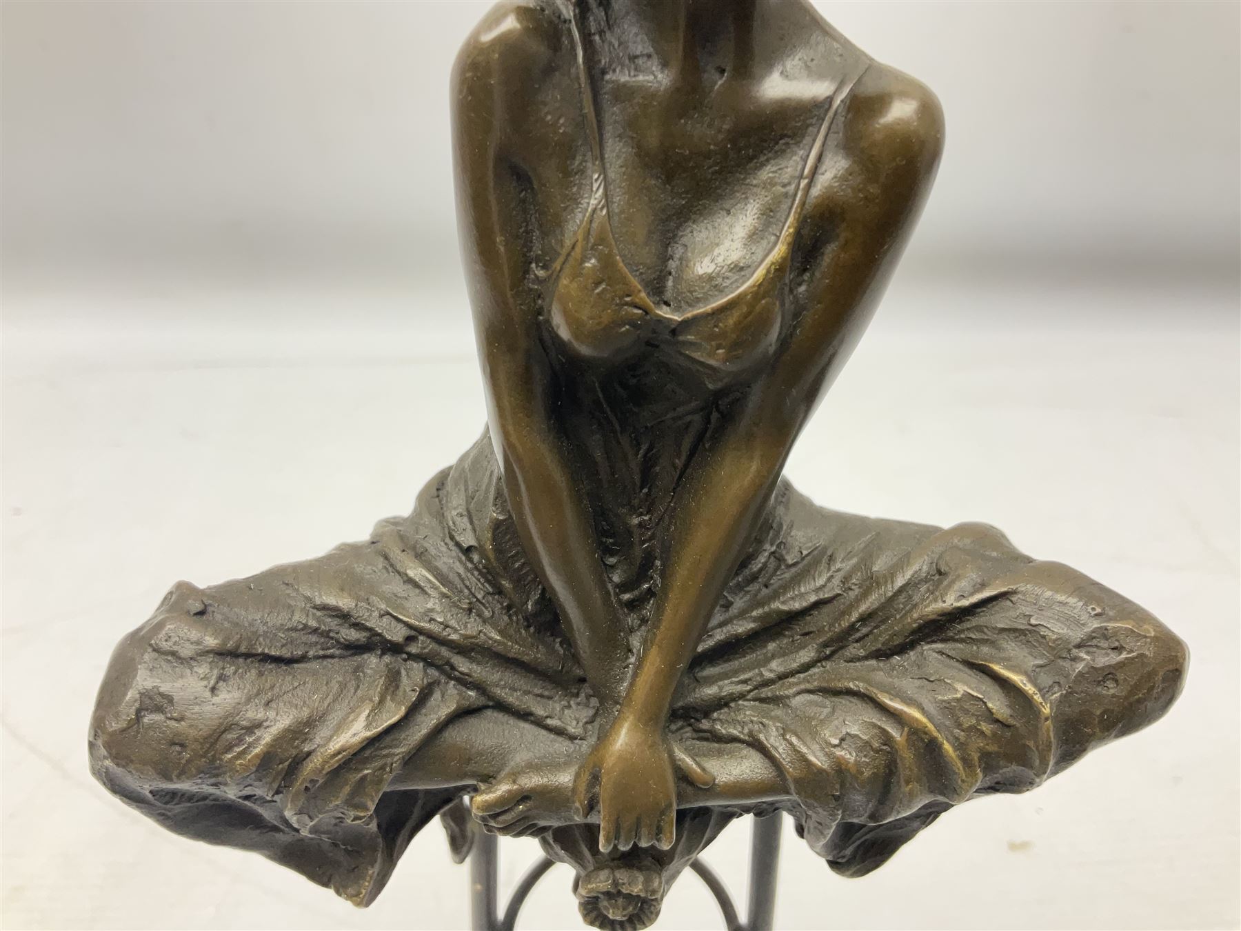 Art Deco style bronze modelled as a female figure seating crossed legged upon a chair, after Pierre Collinet, H28cm