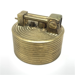 A Brilux Modele Depose Art Deco style brass table lighter, of cylindrical form with concentric ribbed decorated, marked beneath, H6cm. 