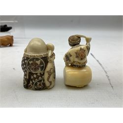 Group of ten Japanese netsukes, comprising eight carved wooden examples, and two ivorine examples, of various form, examples modelled as pigs, owl, mouse with tortoise upon its back, birds, rabbit, etc. 