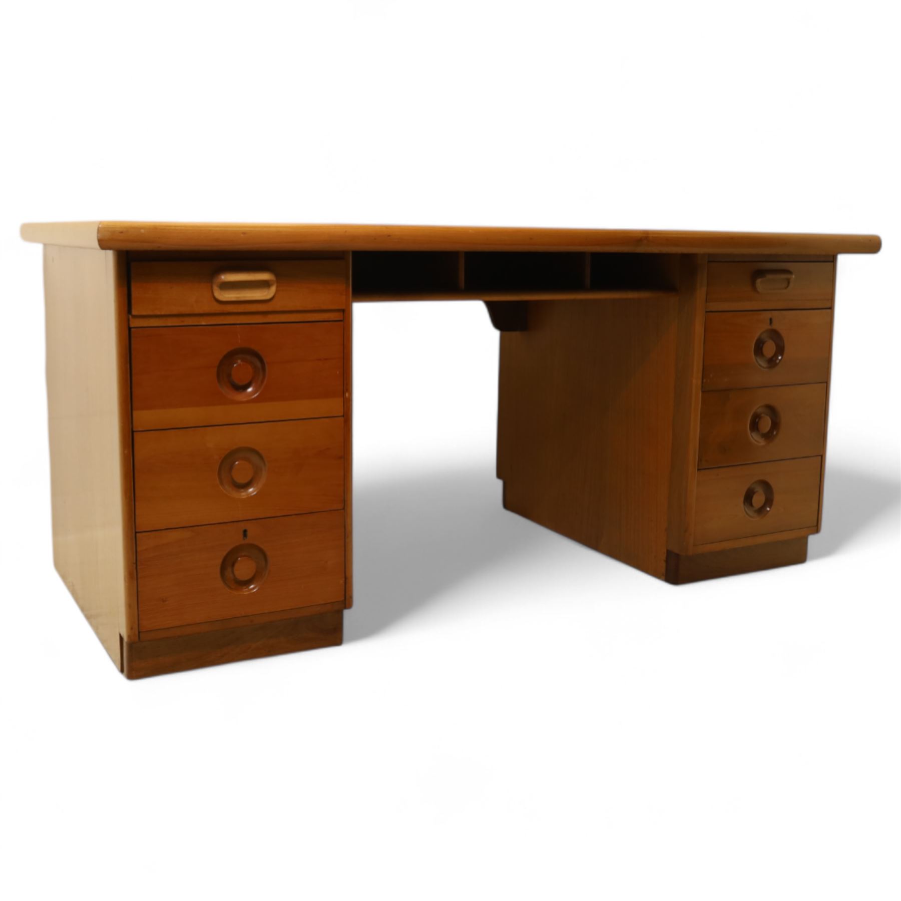 Mid 20th century teak twin pedestal partners desk, rectangular top with rounded corners with integral frieze storage shelf, above  pedestals each fitted with three drawers, recessed circular pull handles, cupboard doors fitted to the opposing side on concealed plinth bases