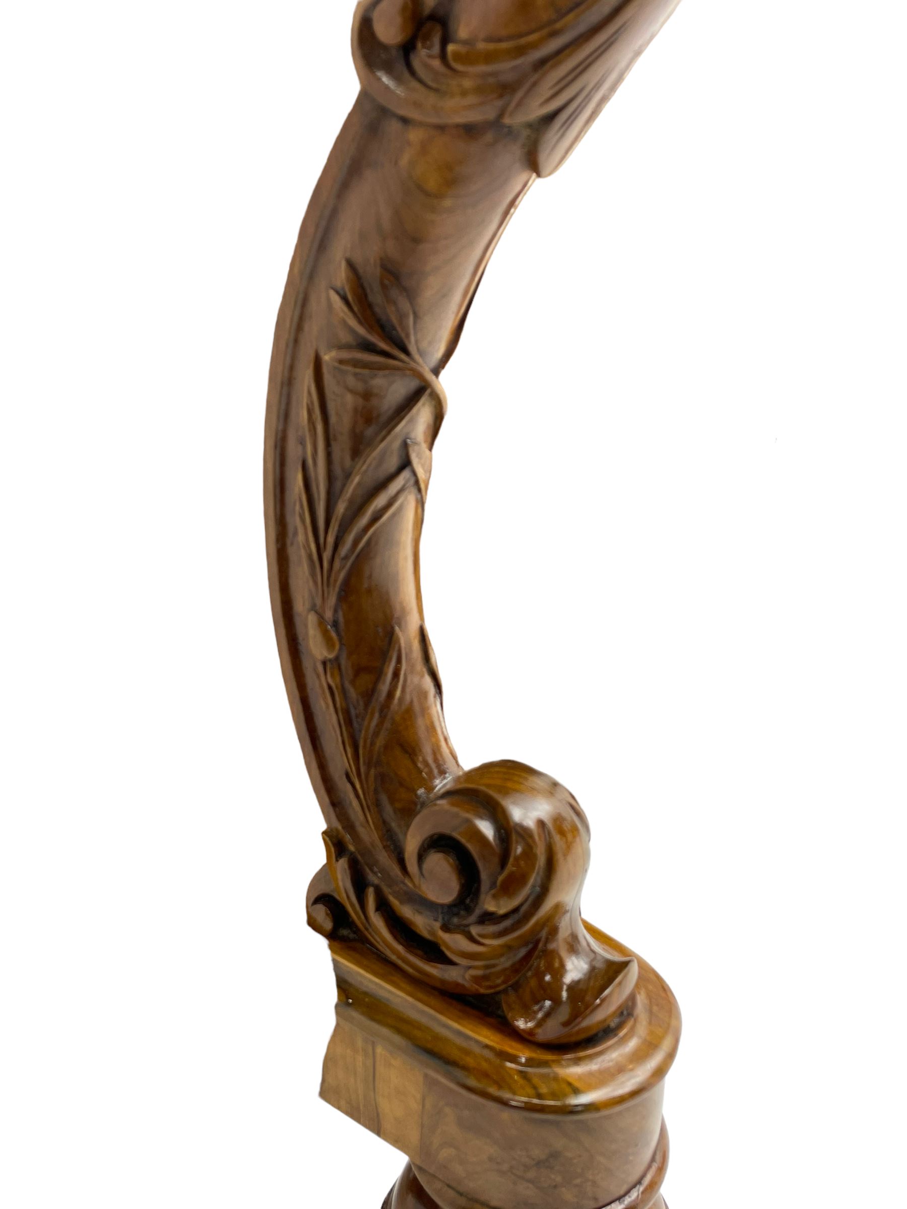 Fine and unusual 19th century olivewood piano top davenport, raised shaped back carved with olive branches and olives, the top hinges to reveal lidded and correspondence compartments, the piano lid enclosing sliding top with hinged and adjustable writing surface with leather inset, right-hand panelled door enclosing four drawers, olive branch and scroll carved cabriole front supports on moulded and shaped platform, turned cup feet with recessed castors 