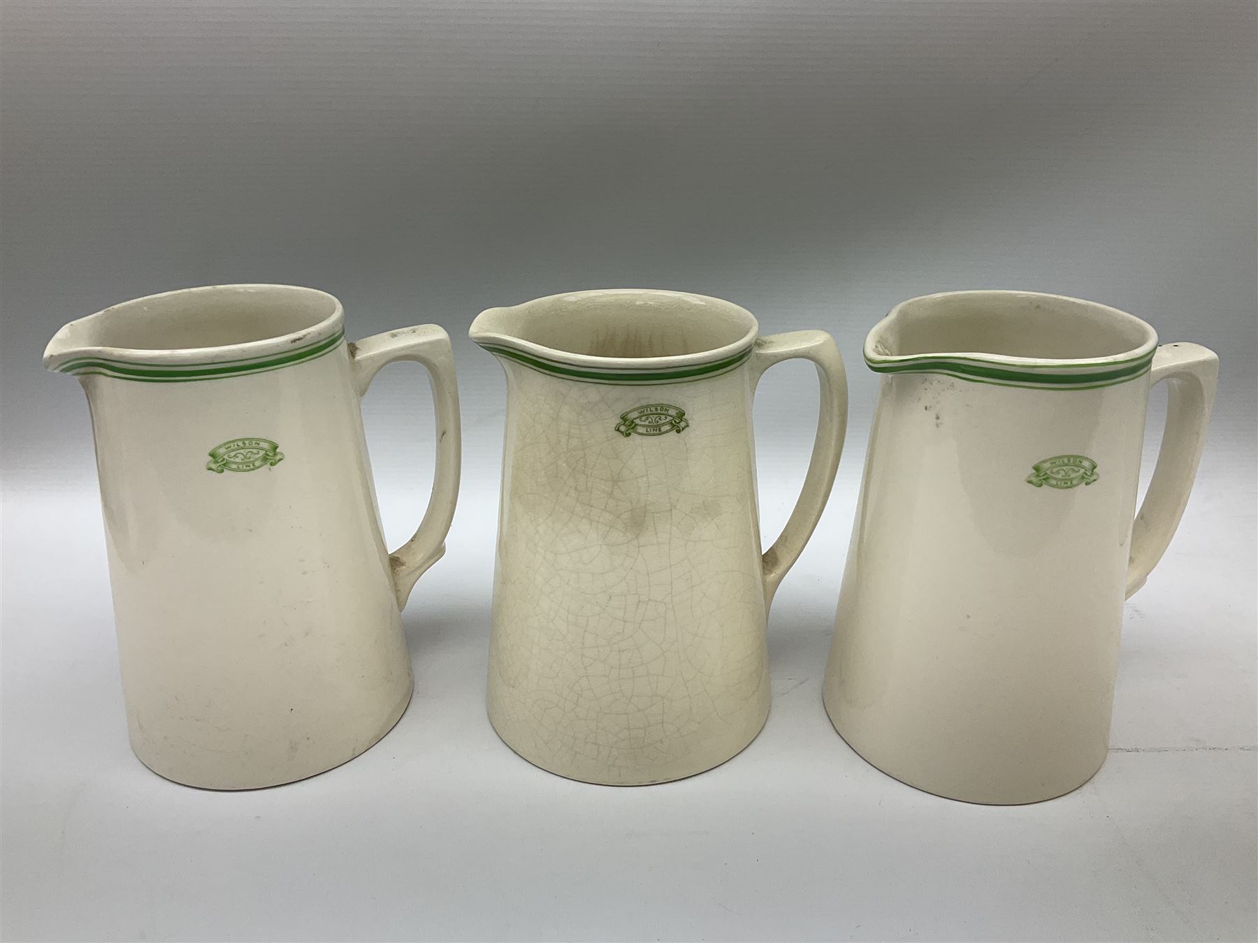 Wilson Line of Hull - five graduated ceramic jugs by Weatherby, Adams and Crown Ducal, largest H22cm, sets of six port and liqueur glasses, four silver plated menu holders and glass ashtray (22)  