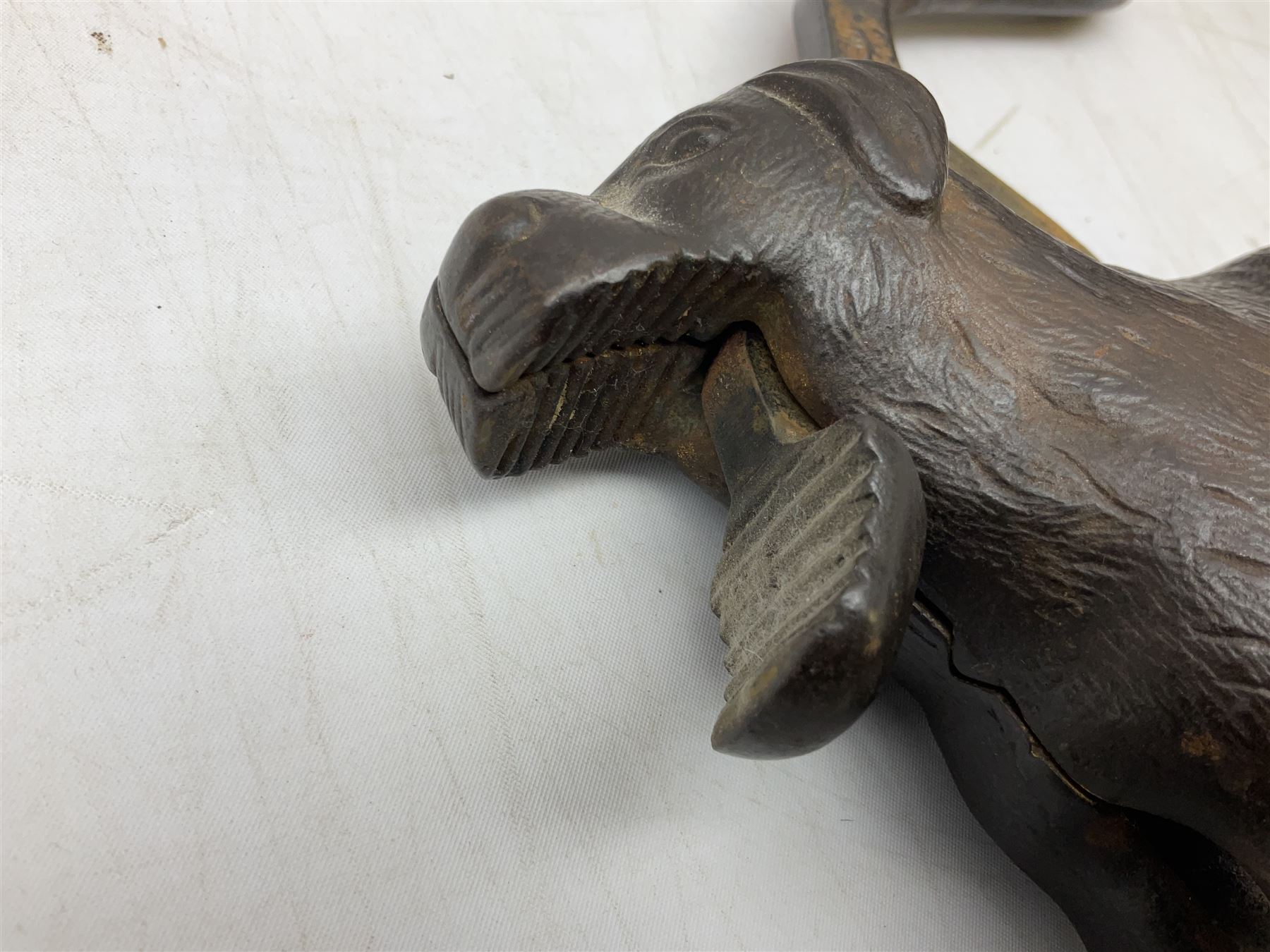 Cast metal nutcracker, in the form of a dog together with a pair of Swift Saratoga 8x40 binoculars in leather case and a hip flask, the glass flask covered in leather to the top with a detachable silver plated cup to base