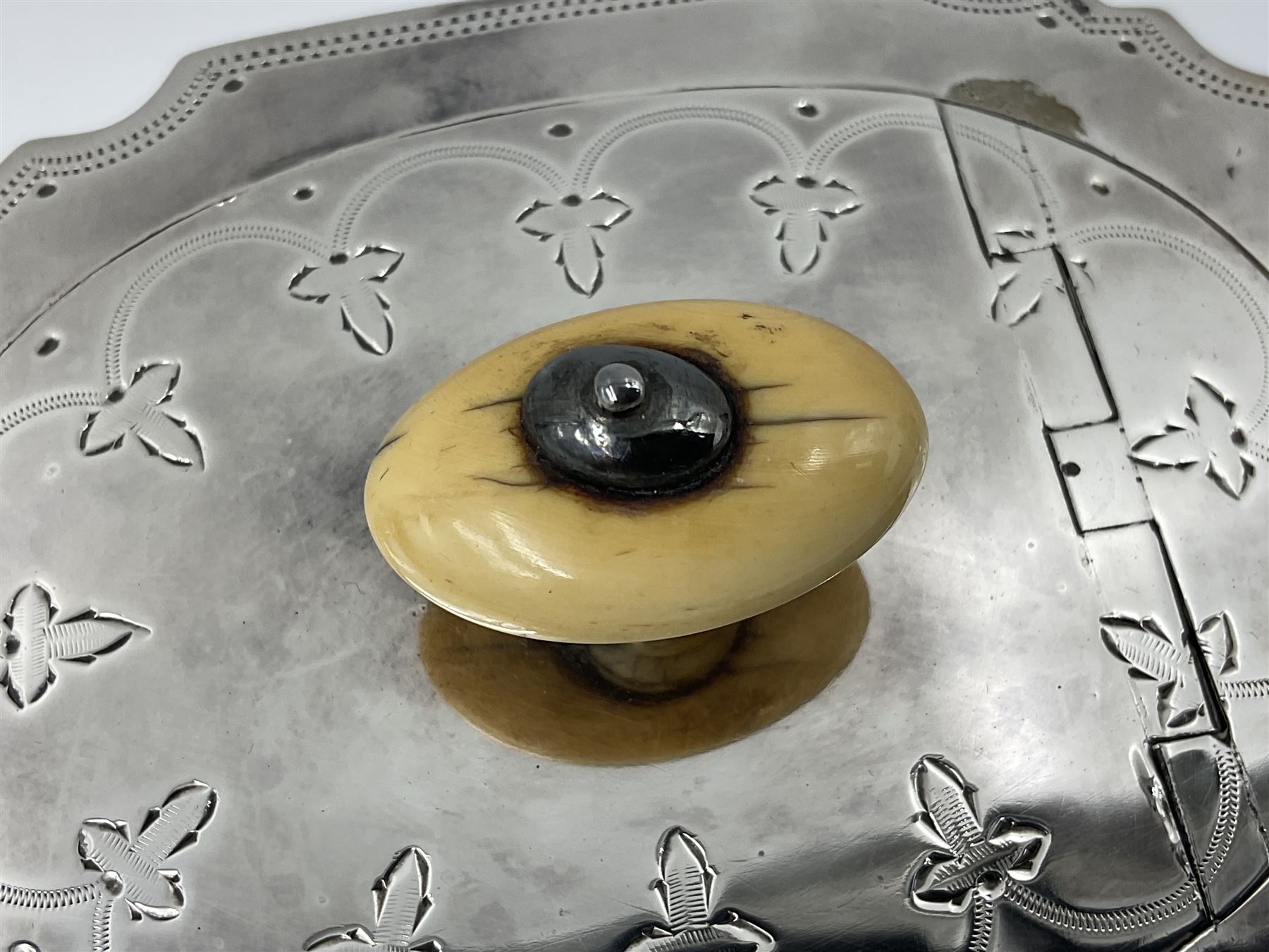 Victorian three-piece silver tea service, comprising teapot, twin handled open sucrier and milk jug, of oval form with shaped rim and C handles, each engraved with crests and bands of strapwork decoration, the milk jug and sucrier with gilt interiors, hallmarked Josiah Williams & Co, Exeter 1881, the teapot with ivory insulators and finial, all contained with a tooled leather, blue silk and velvet lined fitted case, retailed by West & Sun, Dublin 
This item has been registered for sale under Section 10 of the APHA Ivory Act