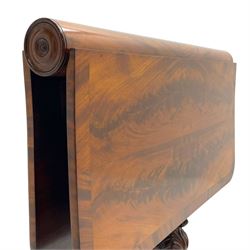 Unusual William IV mahogany Sutherland table, figured and book-matched rectangular drop-leaf top on cylindrical barrel movement, turned roundels to each end, on turned pedestal with acanthus carved baluster, shaped platform with four extended paw feet
