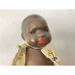 Heubach Koppelsdorf 399 mulatto bisque socket head doll, with brown glass sleeping eyes, painted mouth and pierced ears, with jointed bent limp body, marked 'Heubach Koppelsdorf, 399. 14/0, Germany, DRGM', donning original clothes