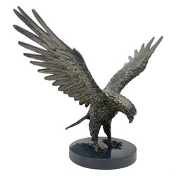 Bronze eagle, modelled in a standing position with wings spread, raised on a black veined marble circular plinth base, H29cm