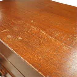 Mid 20th century oak chest of drawers, rectangular top with gently rounded front edge over four graduating drawers fitted with recessed ribbed wooden handles, plain drawer fronts, raised on an integral plinth base