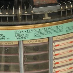 Ditchburn - 'Music Maker Panoramic 200' jukebox circa 1959, curved panoramic glazed front offering full view of the automatic selection process, accommodating 100 records (200 selections), with a stereo sound system, the aluminium trim over a woven speaker grille with an all-over ebonised and silver finish