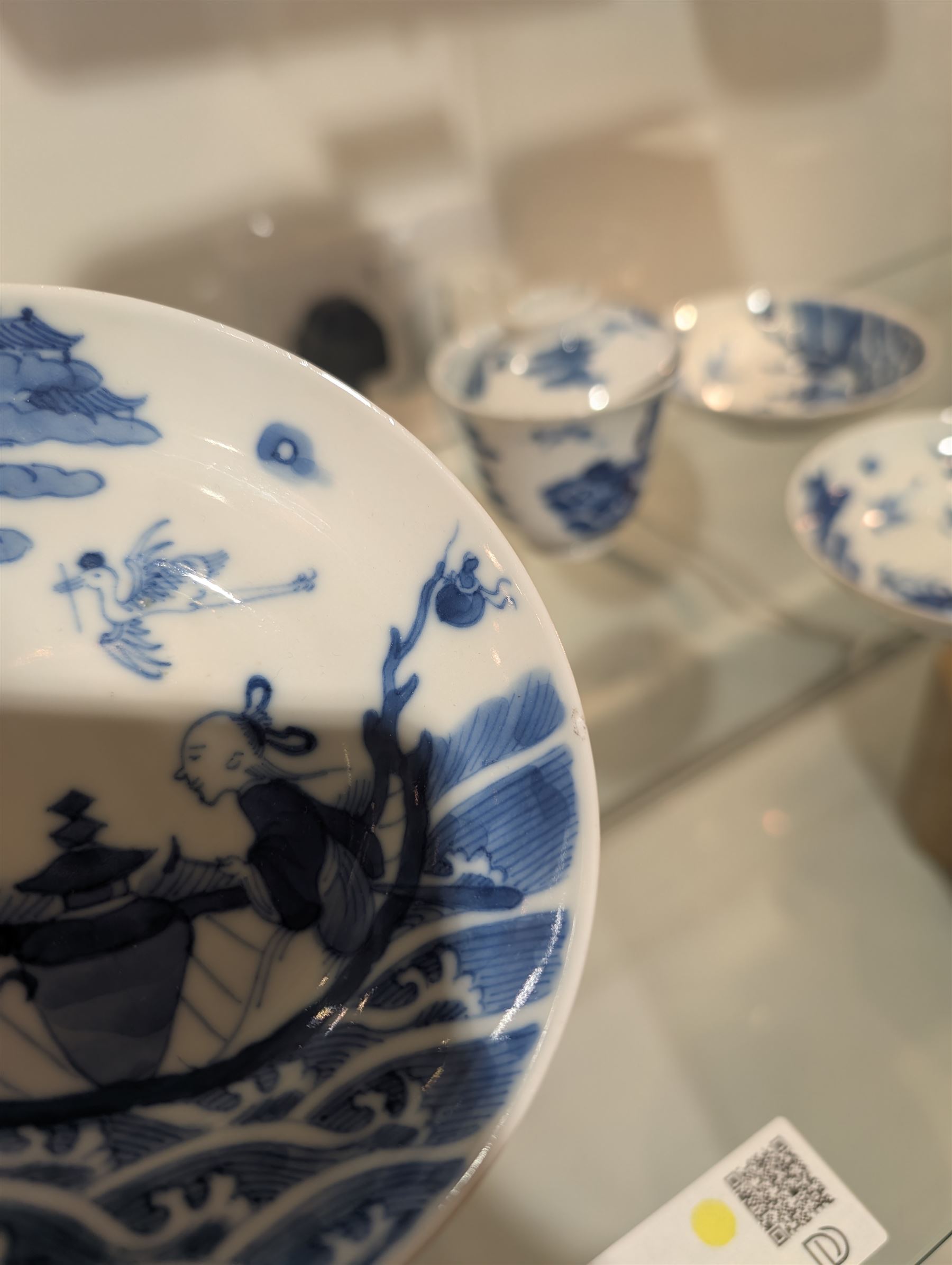 Pair of Chinese blue and white tea bowls, one with cover and four saucers, depicting two figures on a boat at sea, tea bowl H7cm