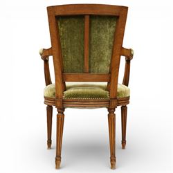 French Louis XVI style walnut armchairs, rectangular upholstered backs with nailhead trim, padded seats upholstered en suite, out-swept arms with upholstered pads, fluted supports with carved rosettes to the knees, on turned and fluted tapering legs