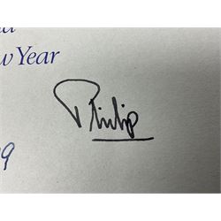 H.M. Queen Elizabeth II and HRH The Duke of Edinburgh, signed 1979 Christmas card with twin gilt ciphers to cover, colour photographic print of the Royal family standing in a garden, signed ‘Elizabeth R and Philip’ with manuscript date 1979 below