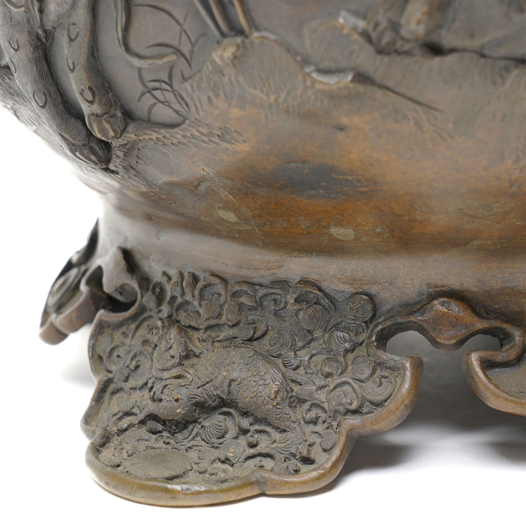 Japanese Meiji period bronze Koro, c.1870-1880, of squat baluster form, each foot with elaborate floral and mythical creature decoration, the body depicting two lions in chase, the rim with Greek key border, the pierced cover with eagle finial, Yoshida foundry mark to base, H50cm