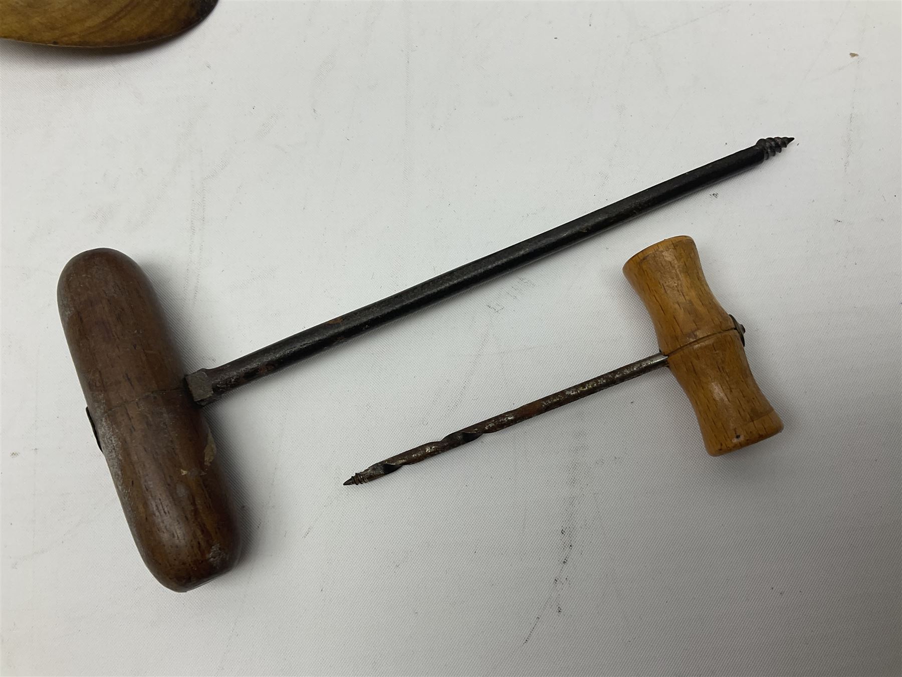 Two wooden biscuit moulds, carved loving spoon and fork, and two bradawls 
