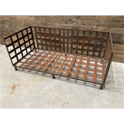 Wrought iron strapwork garden day bed, lattice back and sides