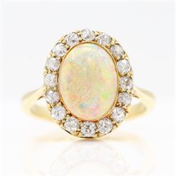 Early 20th century gold opal and diamond cluster ring, single oval cabochon opal, surround...