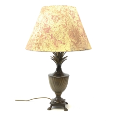 A cast metal table lamp, the base of square form with four pad feet leading to a spreading food, oblique detailed urn form body, and stem detailed with fronds, with marble effect shade, H70cm. 