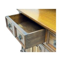 Large mid-20th-century oak dresser with two astragal glazed doors between gallery shelf and lower shelf, with three short drawers and lower section with four drawers and three double-panelled linen-fold hinged cupboard doors 