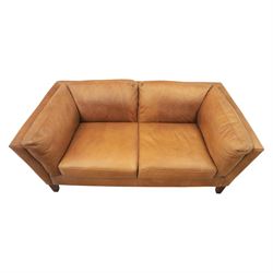 Two seat sofa upholstered in tan leather