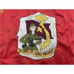1960s North Vietnam banner embroidered in yellow thread on a red ground, roughly translates as 'Peoples Army of Viet Nam. Warriors of Viet Nam Determined To Keep The Country 1964' around a central military crest with the motto 'Warriors Keep The Country'; tassels to three sides 70 x 100cm