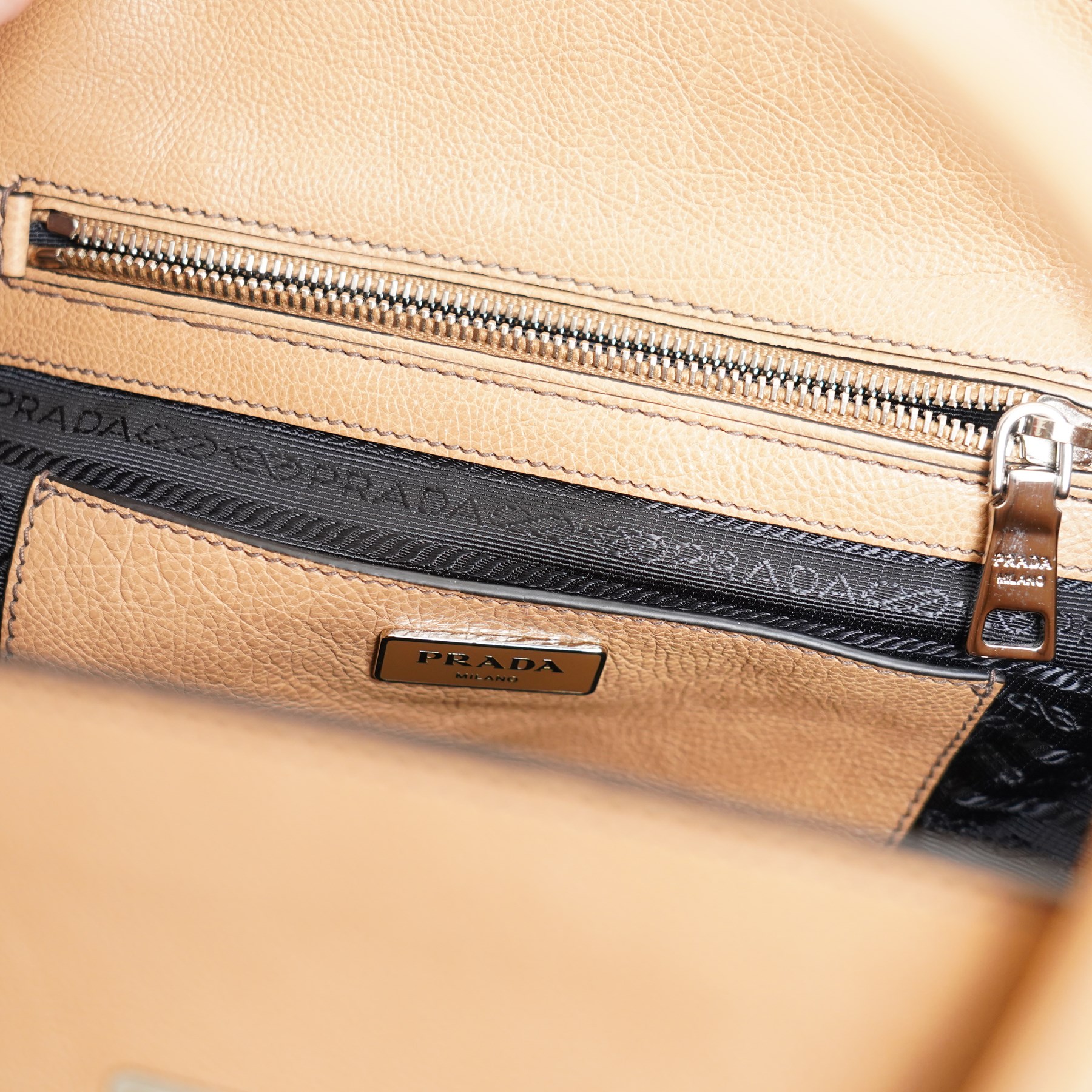 Prada - ‘Sound Lock’ satchel in Naturale Glace Calf leather, with silver-tone push-lock fastening, twin rolled handles, detachable and adjustable shoulder strap and hanging leather clochette, with original product tag, authenticity cards and dust bag