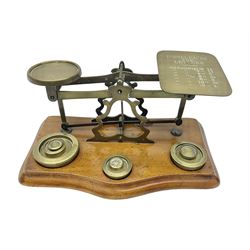 Set of brass postal scales, on wooden base