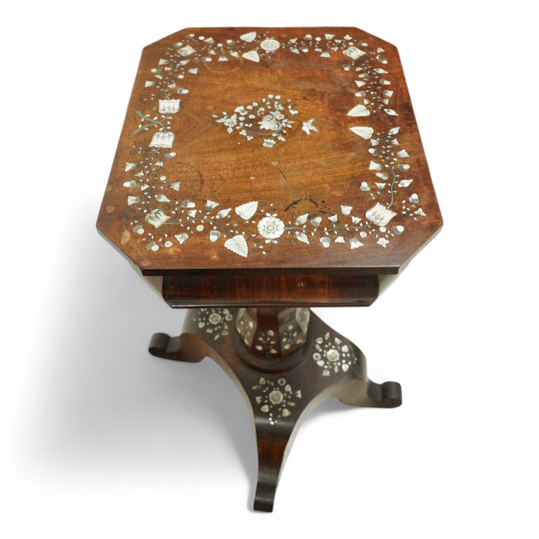 Victorian Mother-of-pearl inlaid rosewood work table, octagonal top inlaid with silvered brass and mother-of-pearl trailing branches of acorn, leaf, and flowering bud decoration, bombe shaped apron with mother-of-pearl leaf inlaid escutcheon, hinged lid with folding mirror, and interior with six lidded compartments and hinged pin cushion above acanthus carved and inlaid pedestal on quattro form base with scroll legs