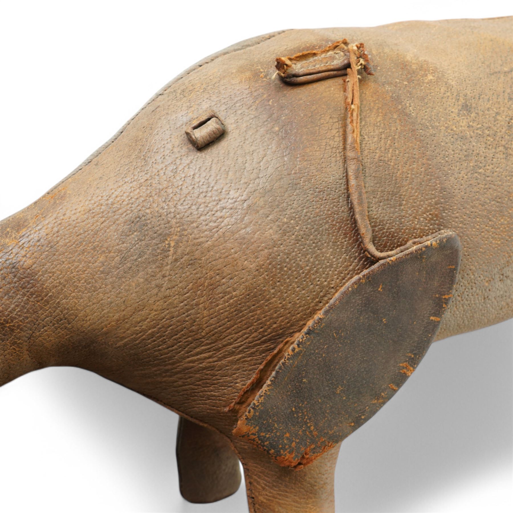 Dimitri Omersa (1927-1975) for Liberty's of London, two mid-20th century brown leather footstools, in the form of a pig and piglet, larger pig bearing Liberty stamp beneath ear, pig W86cm, piglet W49cm
