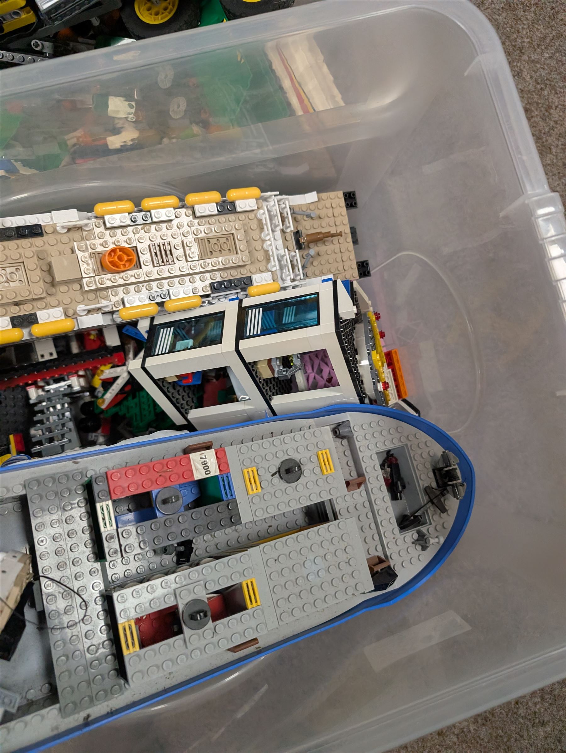 Two boxes of partially built Lego vehicles, including Lego Technics Dumper Truck no. 8264, Titanic, container ships, police boat, smaller police vehicles, etc
