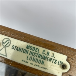 Brass laboratory scales by Stanton Instruments Ltd. Model No. C.B.3, in glazed mahogany cabinet with upward sliding front, two hinged side doors and black vitrolite type base W41cm H45cm; with wooden cased set of brass weights