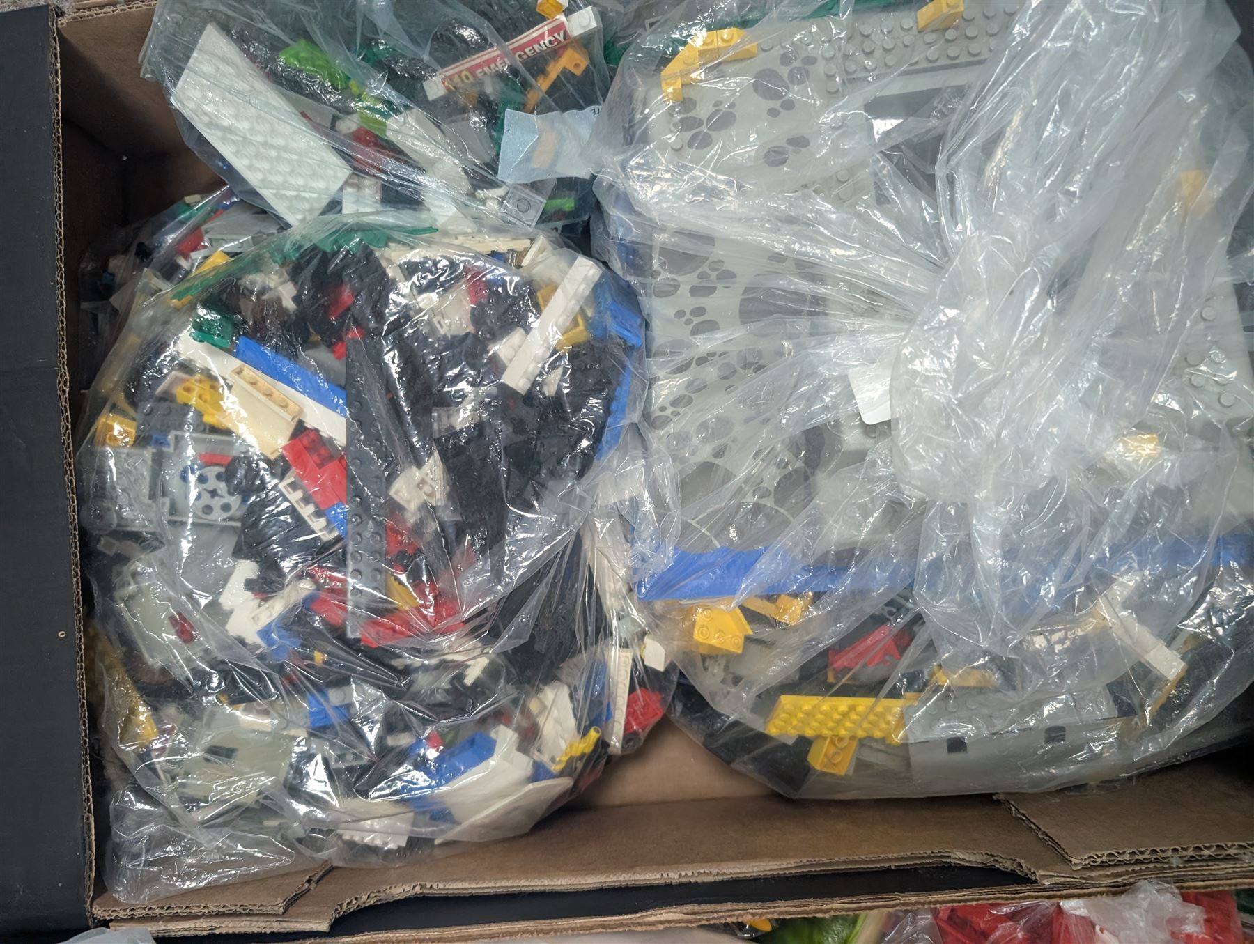 Large collection of loose Lego, including minifigures, together with three Lego ideas books, in five boxes