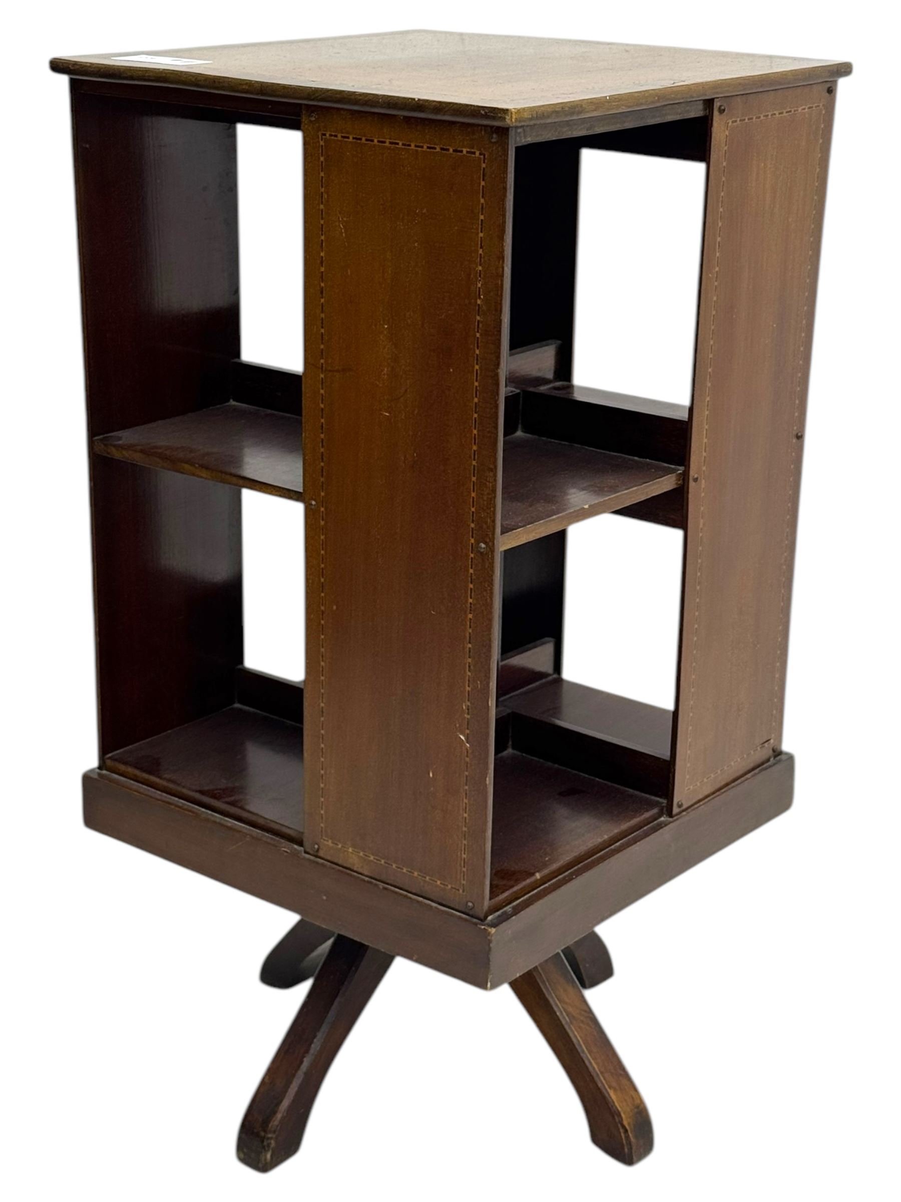 Edwardian inlaid mahogany revolving bookcase, square top, two tier open book compartments, on a cruciform base with splayed feet 