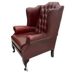 Georgian style wing back armchair, upholstered in buttoned red leather