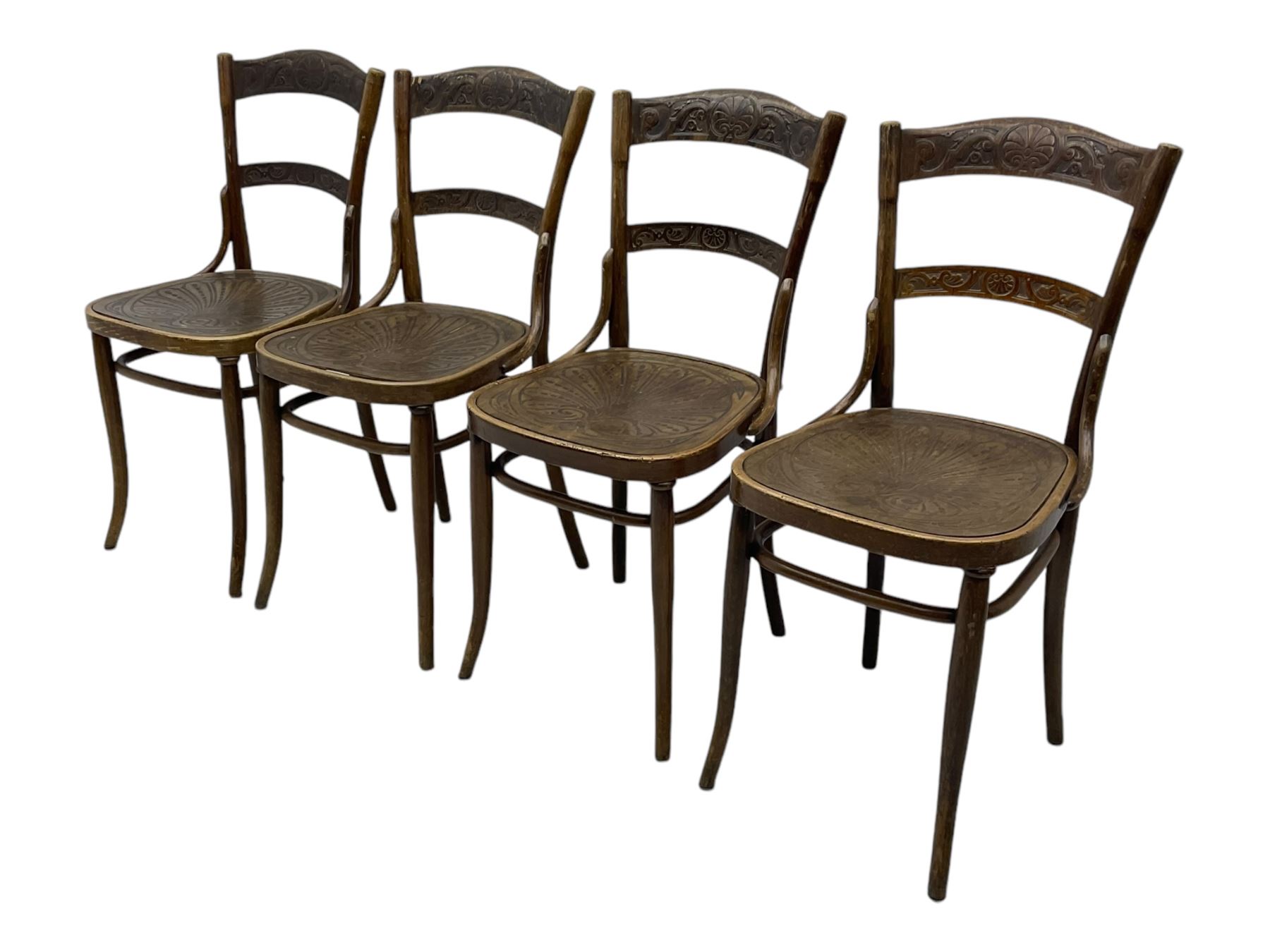 Jacob & Josef Kohn - set of four early 20th century Austrian bentwood chairs, each with carved decoration to the shaped backrest and shaped seat, on splayed supports with stretchers, marked with the manufacturer's stamp and paper label beneath