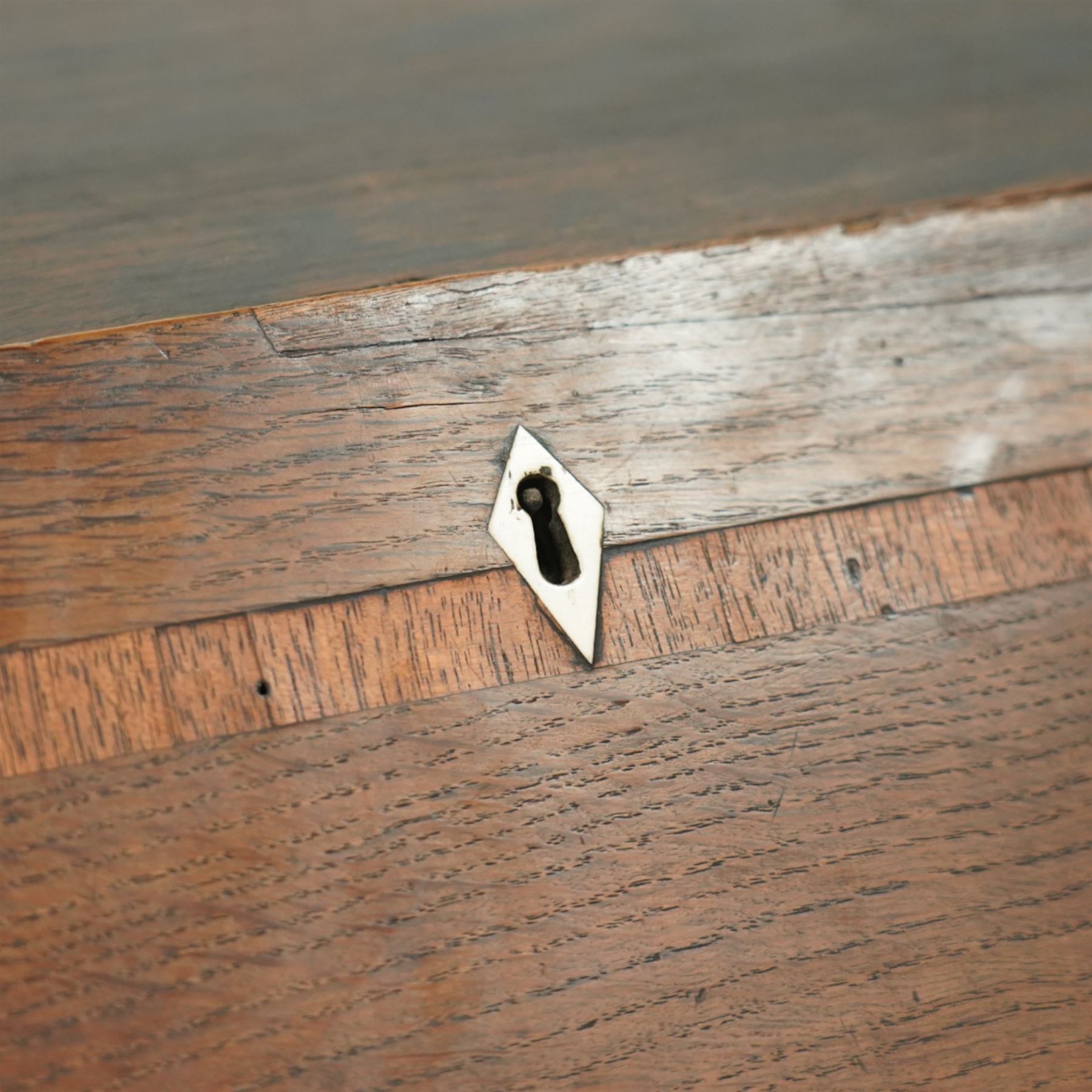 George III oak bureau, the fall front enclosing a fitted interior of small drawers and pigeonholes, above seven graduated drawers with brass plate handles and bone escutcheons, raised on bracket feet