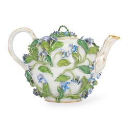 Late 19th century Meissen teapot, of ovoid form with gilt detailed 'crabstock' effect handle and spout, the body encrusted with forget-me-not flowers and leaves and painted with a single moth, with underglaze blue crossed swords mark beneath, H10cm