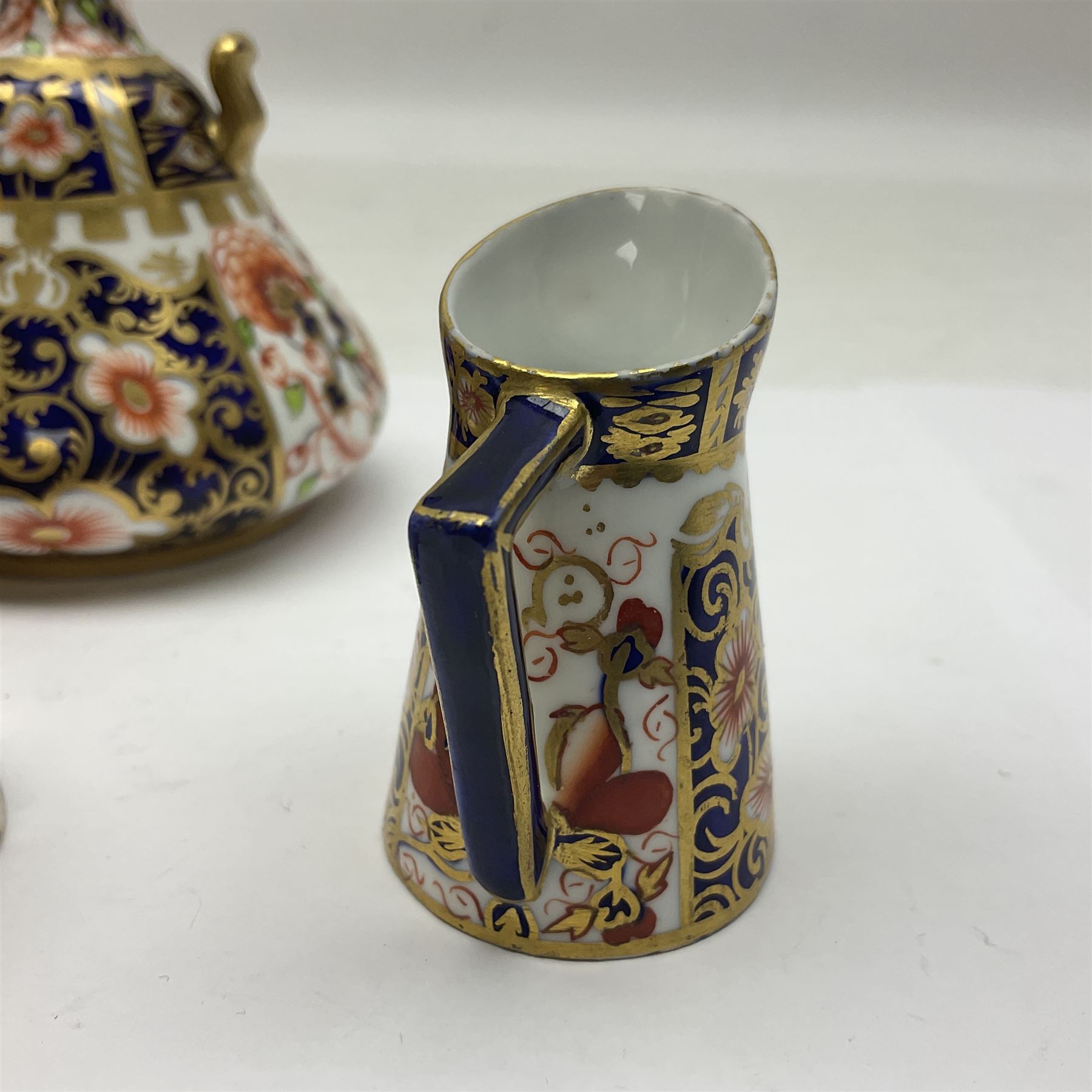 Pair of Royal Crown Derby 6299 imari pattern miniature vases, together with a miniature pitcher and dish in 2451 imari pattern, all with printed marks beneath, vase H12cm 