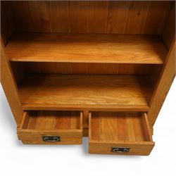 Contemporary oak bookcase, with moulded cornice above open shelved interior, fitted with four adjustable shelves and two short drawers with inset brass handles, panelled sides, plinth base