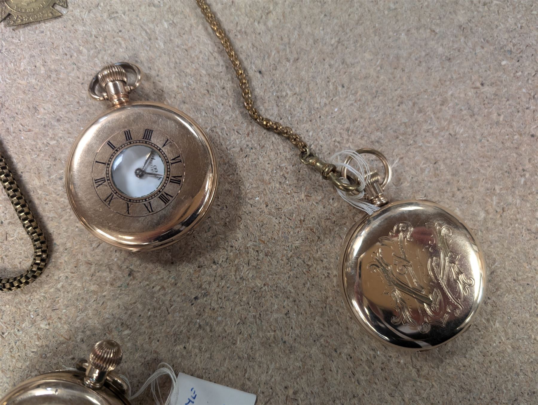 Four early 20th century gold-plated keyless pocket watches, three by Harris Stone Leeds, Waltham and Elgin and two gold-plated watch chains