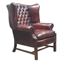  Large 20th century Georgian style wingback armchair, upholstered in buttoned dark brown leather, square moulded supports, W85cm  