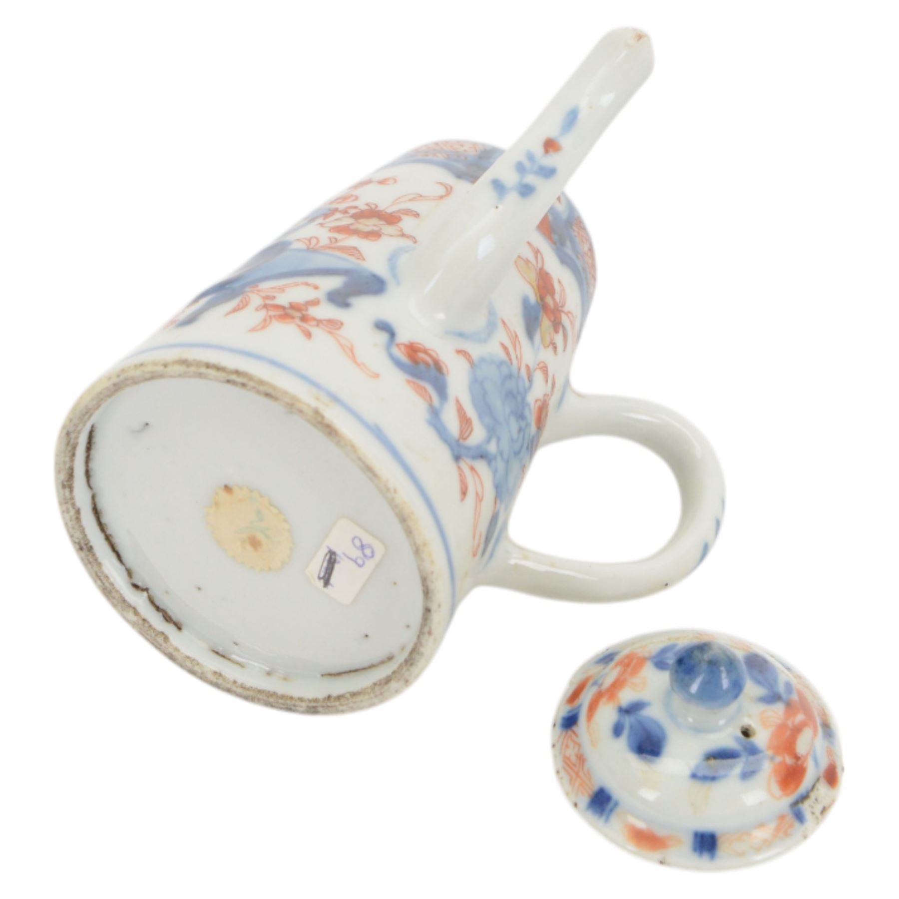 18th century Chinese Imari coffee or chocolate pot, of tapering cylindrical form with side handle, and domed cover with knop finial, painted with a vase of flowers upon a table and scroll, amongst blossoming flowers, H12cm 