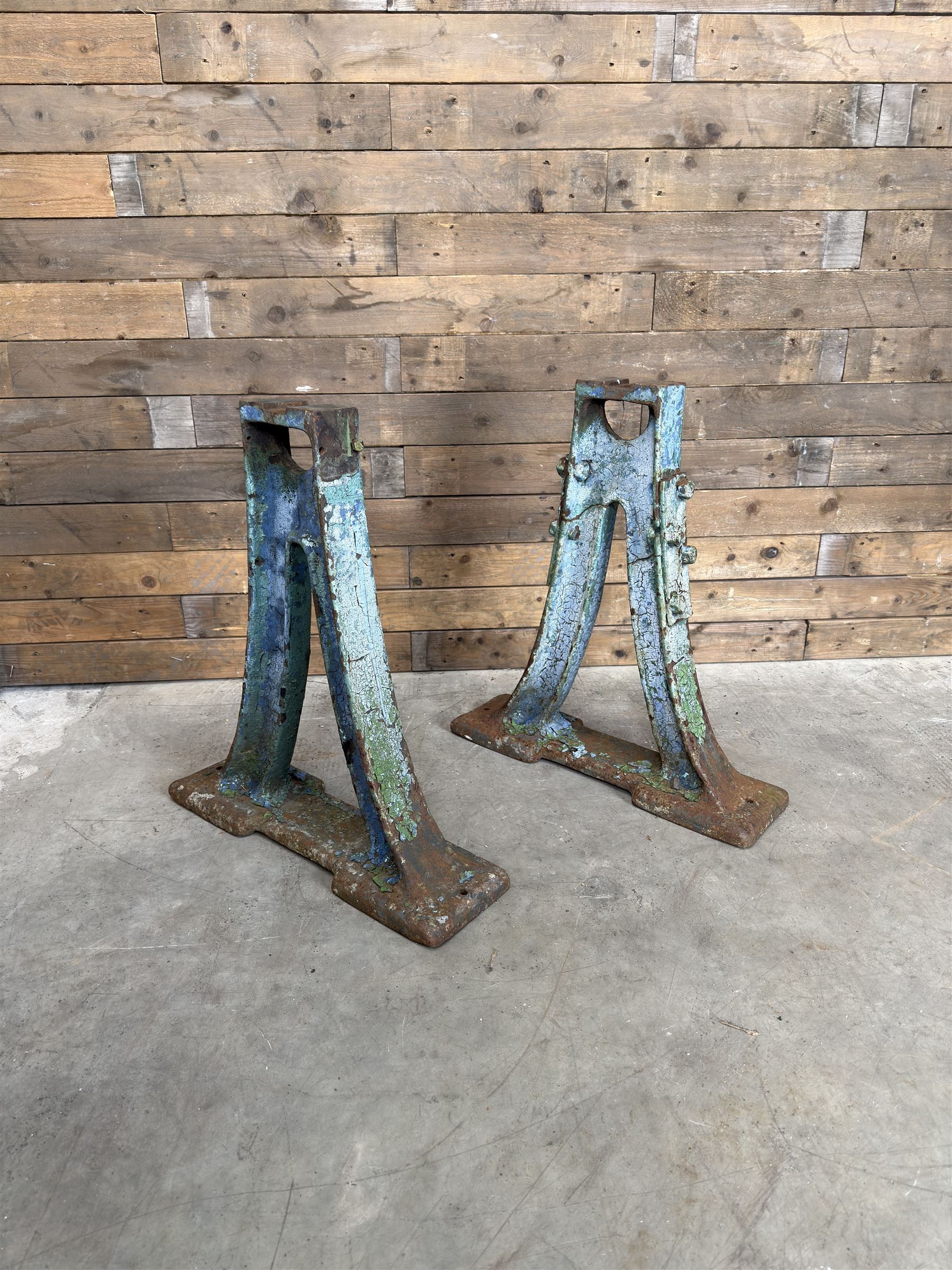 Pair of late 19th century heavy cast iron garden industrial trestles, painted in distressed blue paint