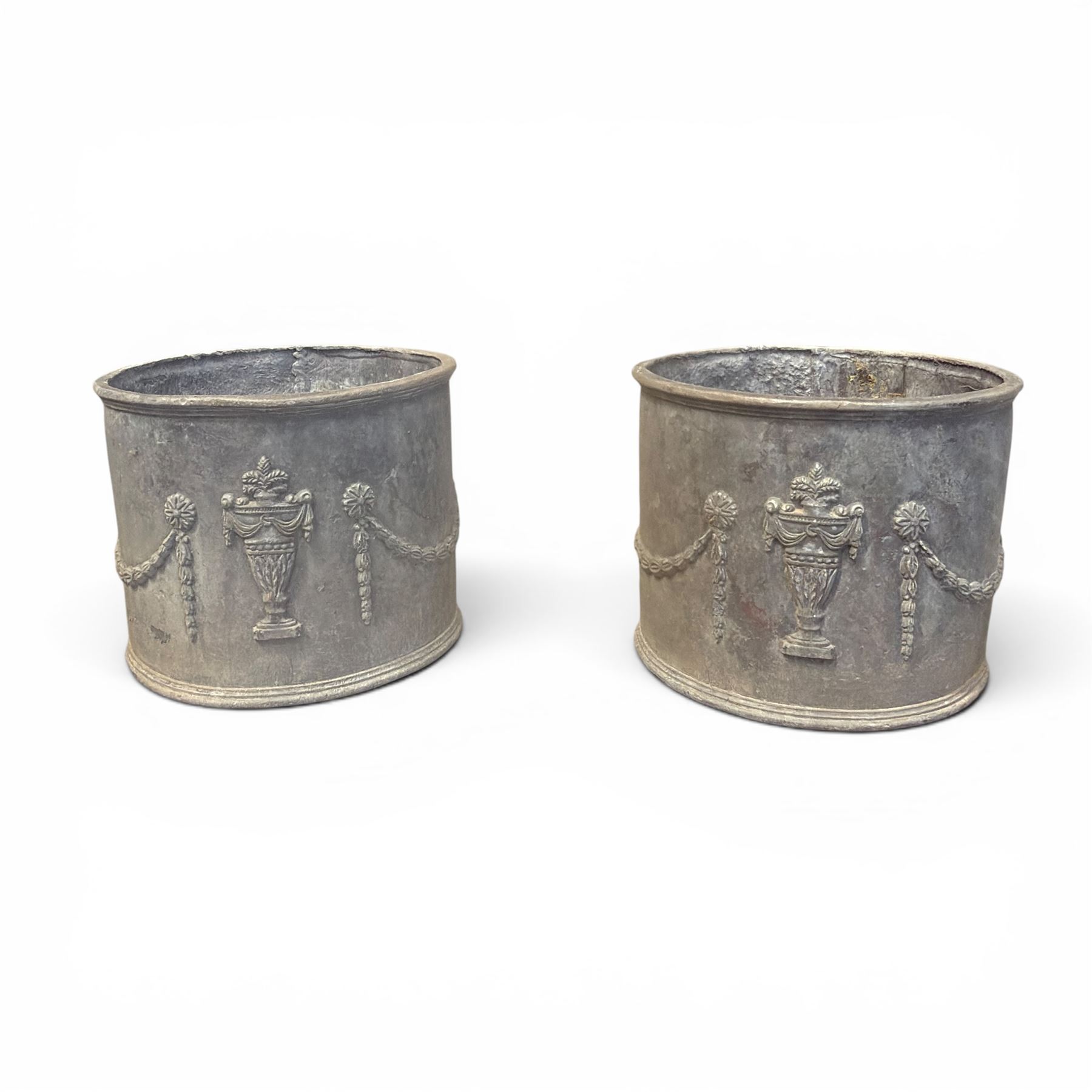 Pair of 19th century Neoclassical design lead garden planters of cylindrical form, the body decorated with an ornate central urn with swags and foliate design, flanked by festoons of bellflowers with roundel motifs