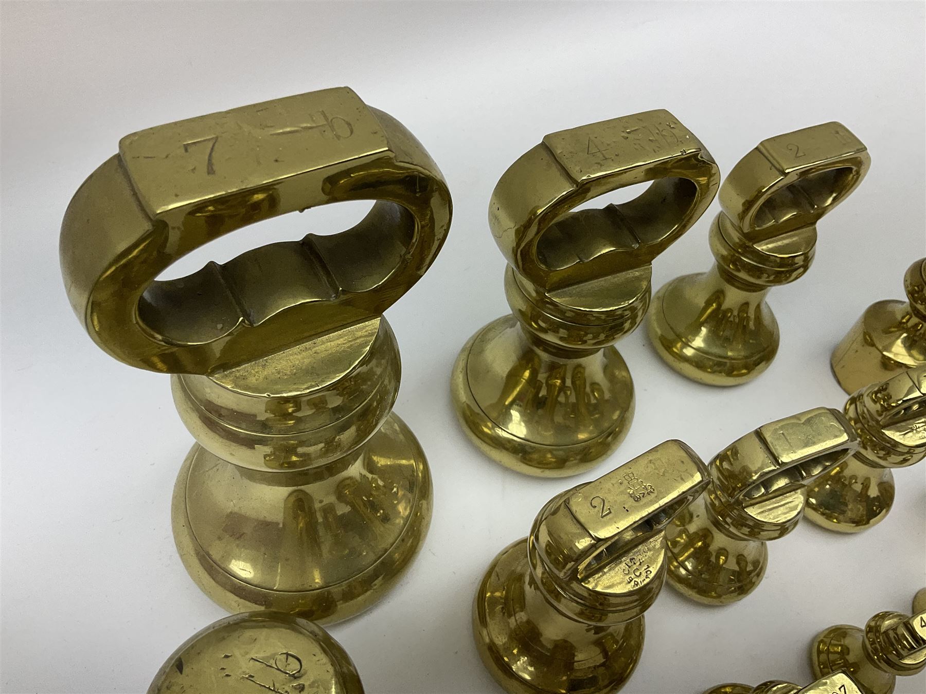 Graduated set of eight brass bell weights, together with a set of five graduating weights (13)
