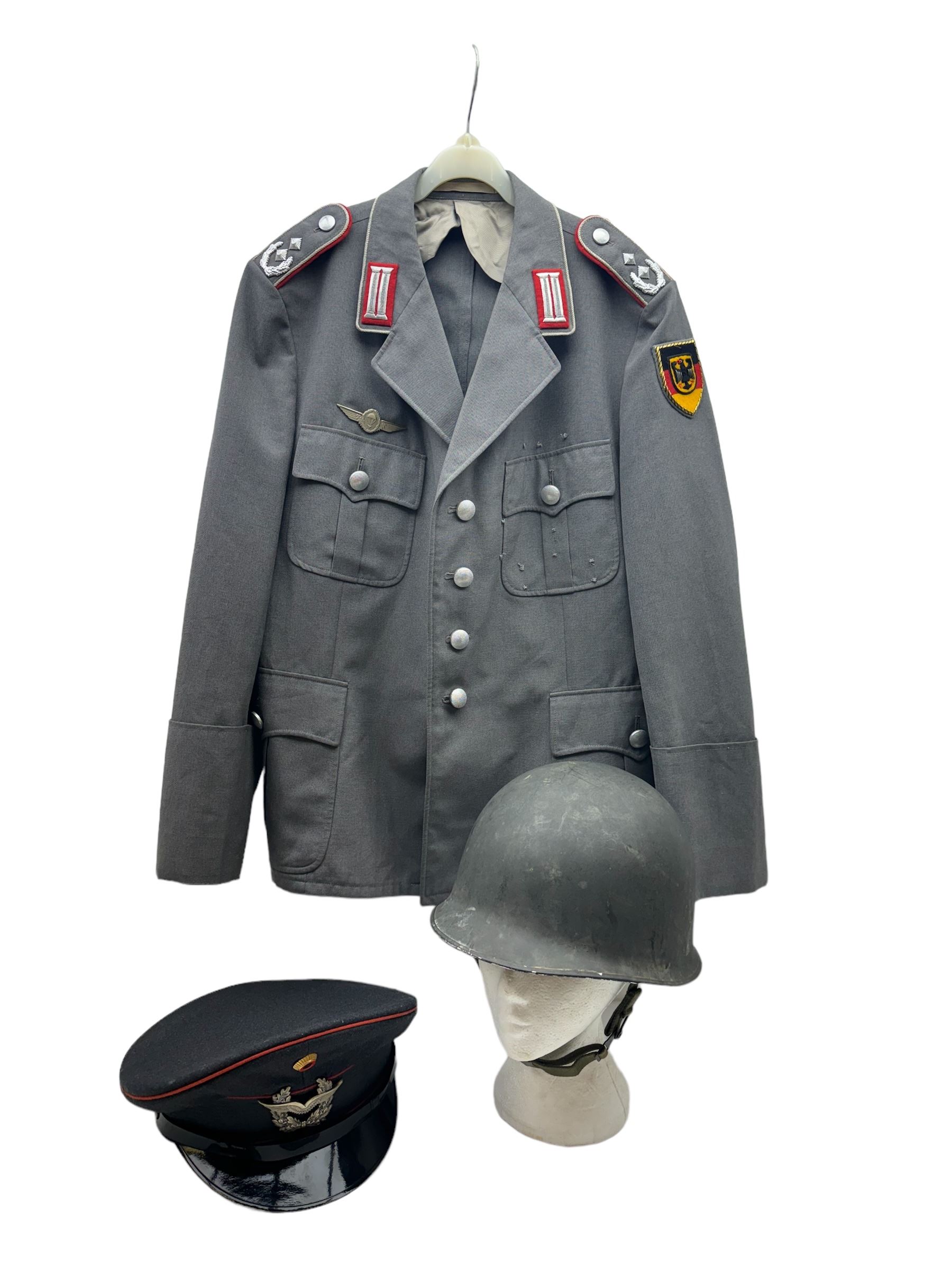 West German helmet steel helmet, together with 1960's peak cap and tunic with German insignias 