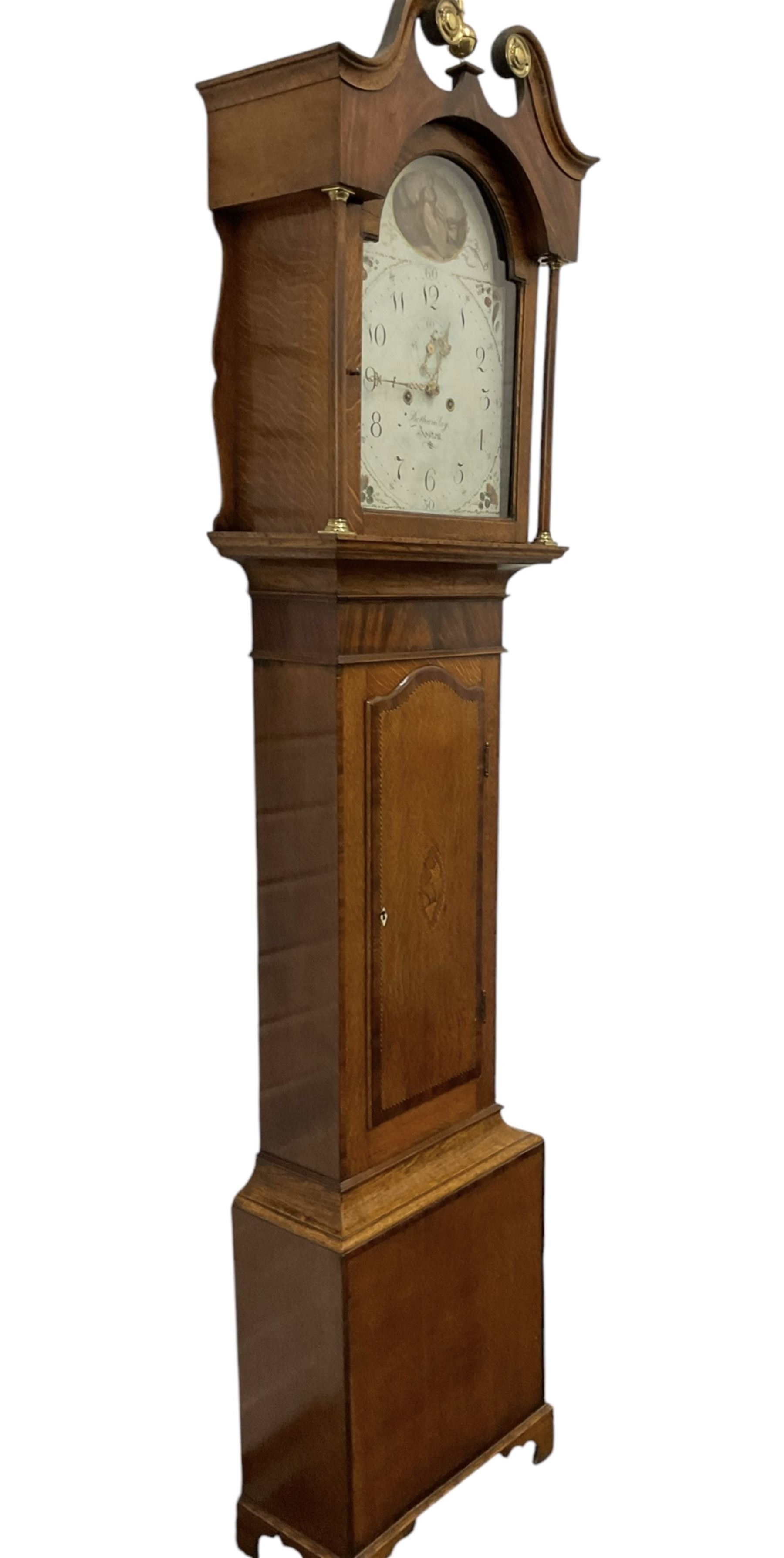Benjamin Bothamley of Boston (Lincs)-Early 19th century oak and mahogany 8-day longcase clock c 1820,  with a swan neck pediment, brass ball and spire finial and paterie, with detached pilasters to the hood door and curved back spats, trunk door with inlay, crossbanding and shaped curved top, rectangular plinth raised on bracket feet, painted dial with images of fruit to the spandrels and  a cameo depiction of a maiden and dog to the arch, with upright Arabic numerals for the hours and quarter minutes, minute markers, seconds dial and stamped brass hands, dial pinned directly to a rack striking movement striking the hours on a bell.
With weights and pendulum.
This item has been registered for sale under Section 10 of the APHA Ivory Act