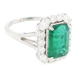18ct white gold emerald and diamond cluster ring, single octagonal cut emerald of approx 2.90 carat, surrounded by twelve round brilliant cut diamonds and four oval cut diamonds to each corner, stamped 18K, total diamond weight approx 0.90 carat