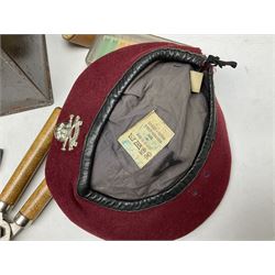 Assorted militaria including ten leather or canvas cartridge and other belts, maroon beret with 17th Lancers cap badge, modern bullet mould, leather and brass shot flask, two knives, shell cases, boomerang etc; in tin deed box